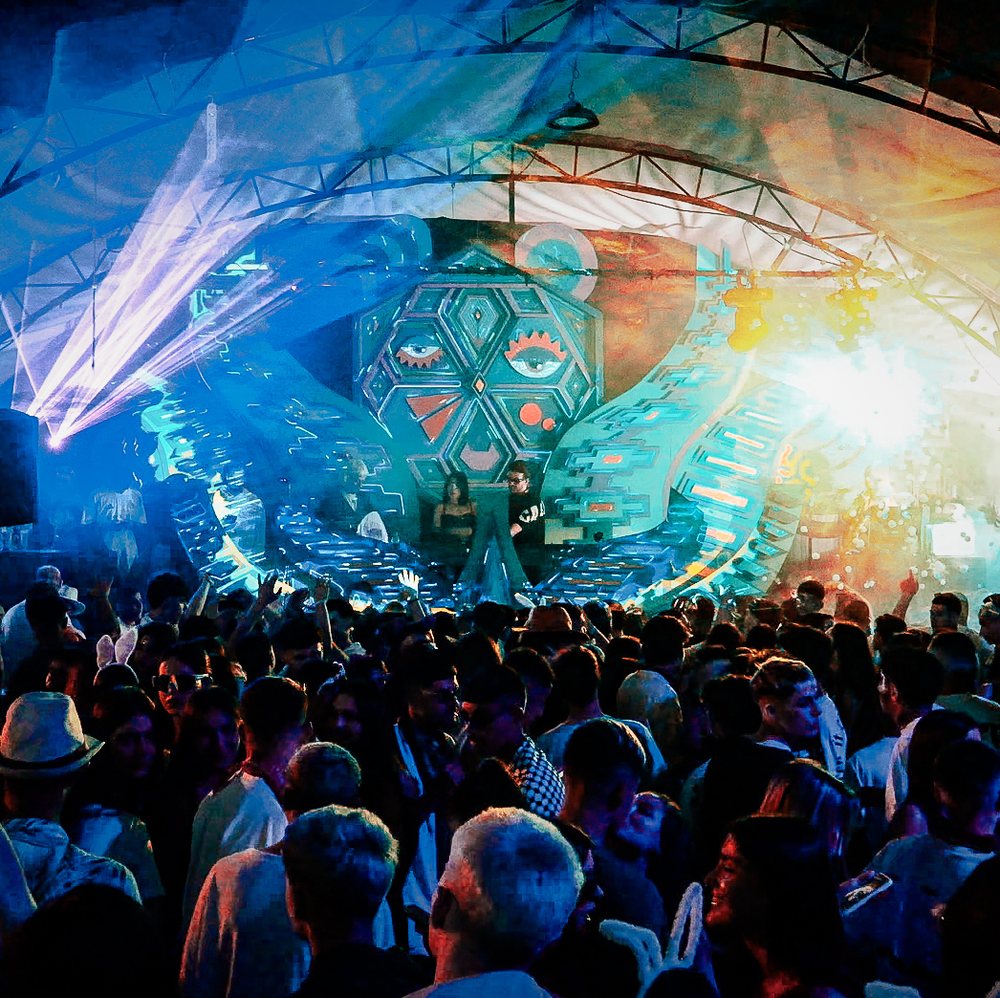 Festival stage with lasers above a crowd at FunkyTown 2025